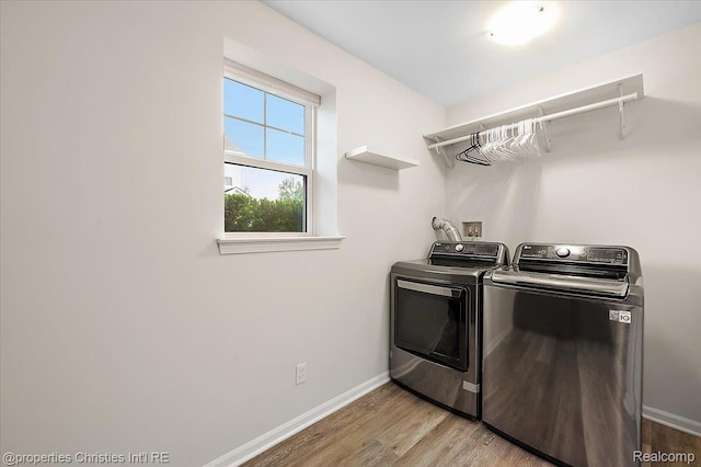 4953 Treeside Ln, Troy, MI 48098 - laundry room with washing machine and clothes dryer and light wood-style flooring