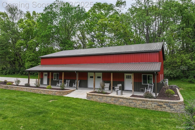 490 Rolling Oaks Dr, Howell, MI 48843 - view of front of property with a porch, a front yard, metal roof, and a garage