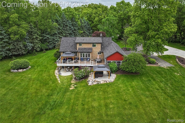 490 Rolling Oaks Dr, Howell, MI 48843 - rear view of house with a gazebo, a deck, a lawn, and roof with shingles