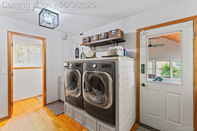 490 Rolling Oaks Dr, Howell, MI 48843 - laundry area featuring washer and dryer, light wood finished floors, and baseboards