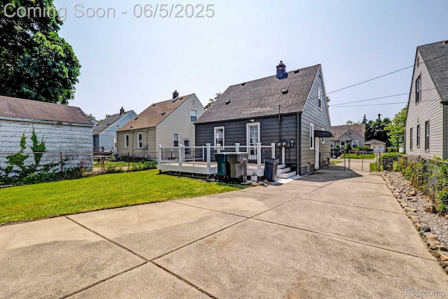 2231 Parker St, Dearborn, MI 48124 - back of property with a residential view, a shingled roof, a chimney, and a deck