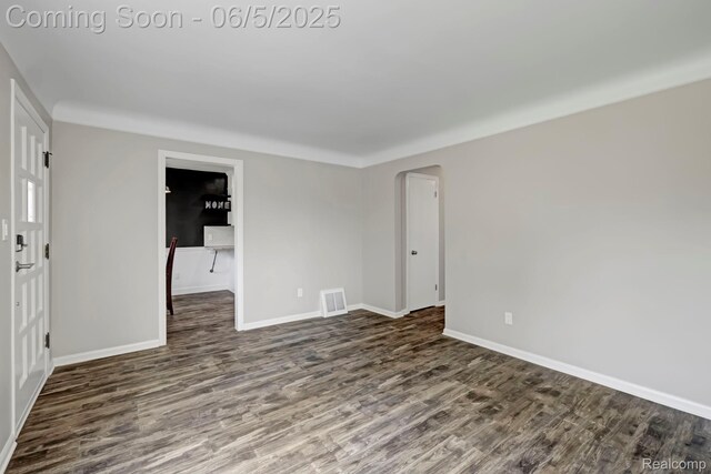 2231 Parker St, Dearborn, MI 48124 - spare room with wood finished floors, arched walkways, and baseboards