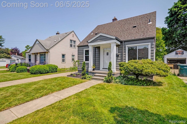 2231 Parker St, Dearborn, MI 48124 - view of front of home with a front yard, roof with shingles, and a chimney