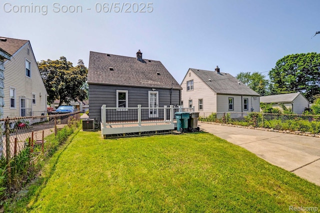 2231 Parker St, Dearborn, MI 48124 - rear view of house with a deck, cooling unit, and roof with shingles