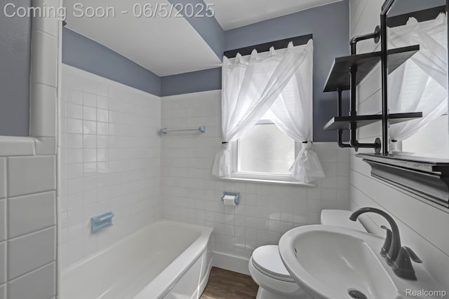 2231 Parker St, Dearborn, MI 48124 - bathroom featuring tile walls, a sink, toilet, wood finished floors, and bathtub / shower combination