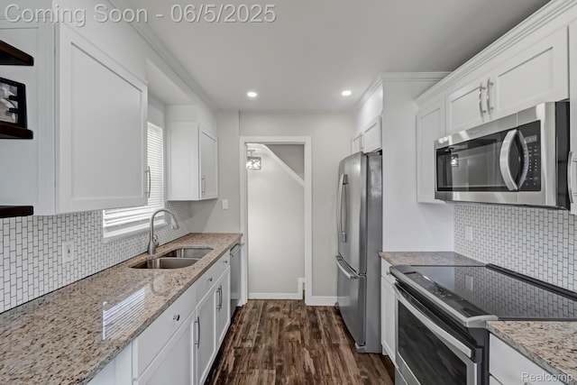 2231 Parker St, Dearborn, MI 48124 - kitchen featuring stainless steel appliances, a sink, white cabinets, backsplash, and dark wood finished floors