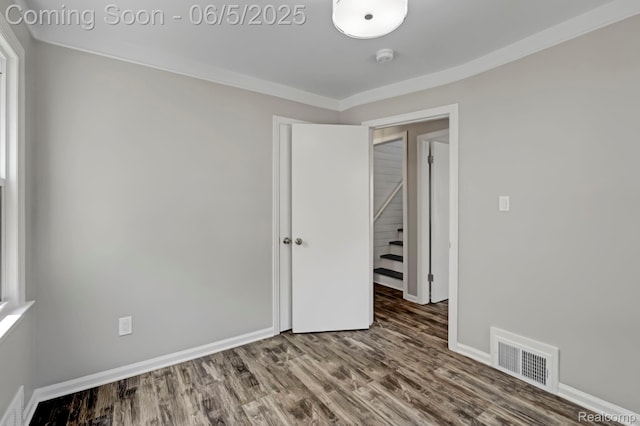 2231 Parker St, Dearborn, MI 48124 - unfurnished room with wood finished floors, baseboards, ornamental molding, and stairs