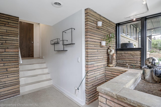 1093 Greentree Rd, Bloomfield Hills, MI 48304 - stairway featuring brick wall, baseboards, and carpet floors
