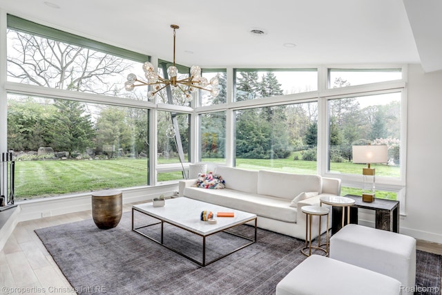 1093 Greentree Rd, Bloomfield Hills, MI 48304 - sunroom / solarium featuring a chandelier and view of scattered trees