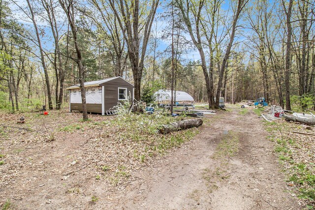 2635 E River Rd, Twin Lake, MI 49457 - view of yard with a wooded view