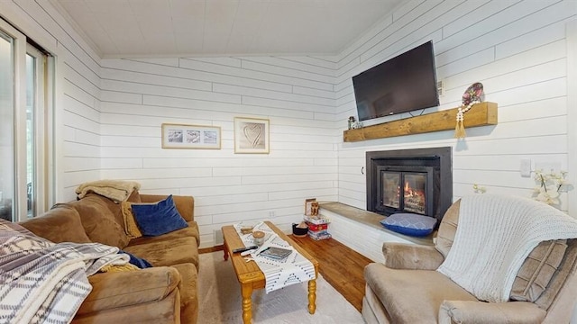 14883 Hideaway Dr, Vandalia, MI 49095 - living area featuring a glass covered fireplace, wood finished floors, and wood walls