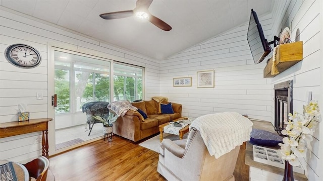 14883 Hideaway Dr, Vandalia, MI 49095 - living room with wood walls, wood finished floors, a ceiling fan, and lofted ceiling