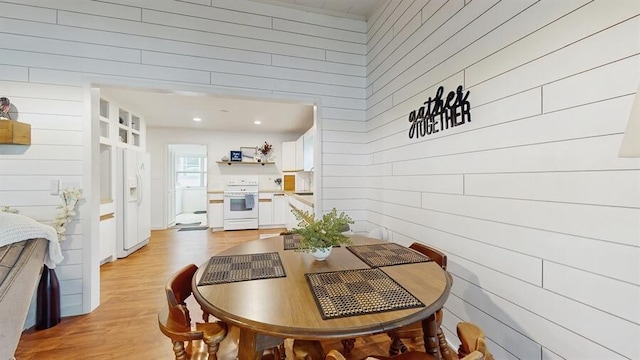 14883 Hideaway Dr, Vandalia, MI 49095 - dining room featuring wood walls and light wood-style flooring