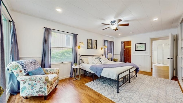 14883 Hideaway Dr, Vandalia, MI 49095 - bedroom with wood finished floors, a wainscoted wall, ornamental molding, a ceiling fan, and recessed lighting