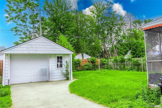 19176 Barlow St, Detroit, MI 48205 - view of yard with driveway, an outdoor structure, and a garage