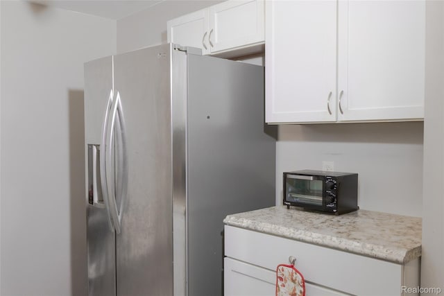 19176 Barlow St, Detroit, MI 48205 - kitchen featuring stainless steel fridge with ice dispenser and white cabinetry