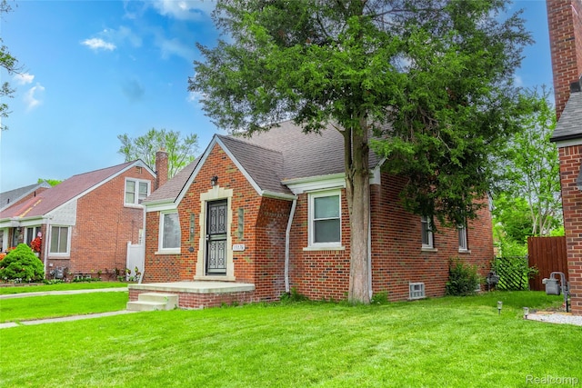 19176 Barlow St, Detroit, MI 48205 - english style home with brick siding, a chimney, and roof with shingles