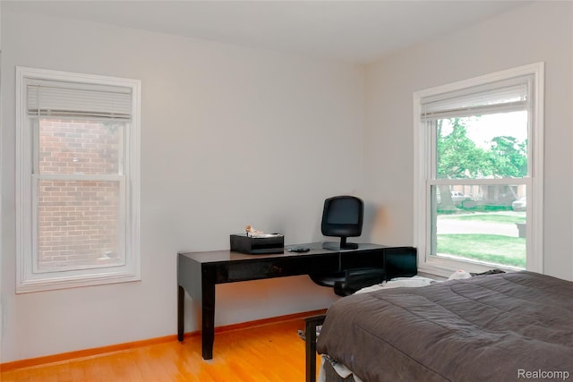 19176 Barlow St, Detroit, MI 48205 - bedroom with multiple windows, light wood-type flooring, and baseboards