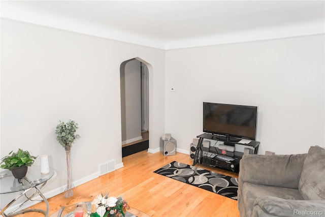 19176 Barlow St, Detroit, MI 48205 - living area with arched walkways, wood finished floors, and baseboards