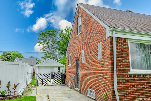 19176 Barlow St, Detroit, MI 48205 - view of home's exterior with brick siding, roof with shingles, and an outdoor structure