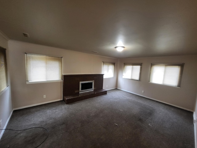 21328 Frazer Ave, Southfield, MI 48075 - unfurnished living room with dark colored carpet, baseboards, a brick fireplace, and ornamental molding