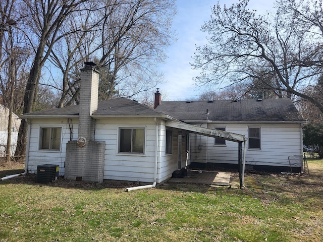 21328 Frazer Ave, Southfield, MI 48075 - back of property featuring a chimney, cooling unit, a lawn, and a shingled roof