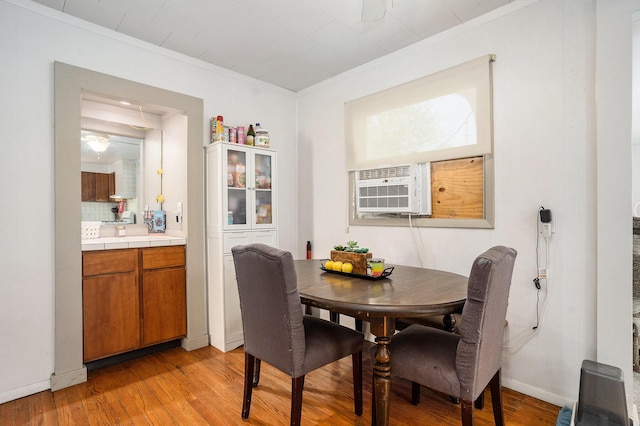 734 Hiways Ave, South Haven, MI 49090 - dining room featuring crown molding, light wood-style flooring, cooling unit, and baseboards