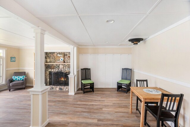 6026 Keeney Rd, Six Lakes, MI 48886 - living area with decorative columns, light wood-style flooring, a fireplace, and recessed lighting