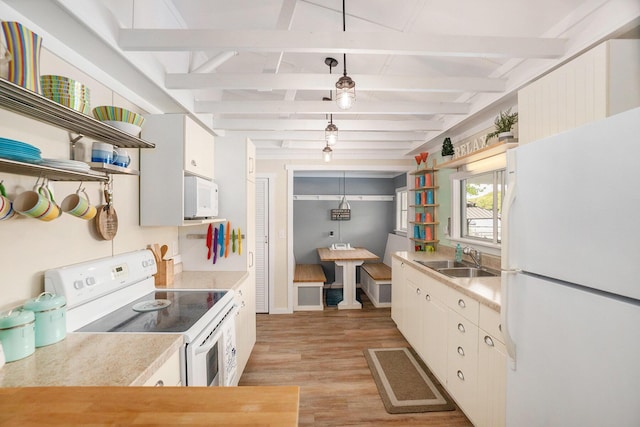 6026 Keeney Rd, Six Lakes, MI 48886 - kitchen with white appliances, open shelves, light countertops, light wood-type flooring, and beam ceiling