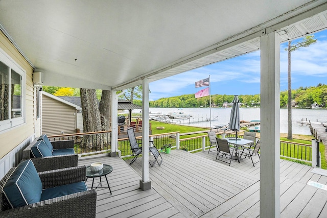 6026 Keeney Rd, Six Lakes, MI 48886 - wooden deck with a water view, outdoor dining space, and a yard