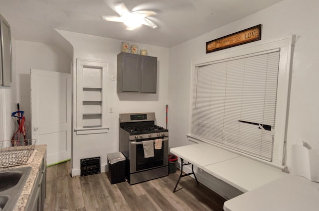 760 Algonquin St, Detroit, MI 48215 - kitchen with stainless steel gas stove, gray cabinetry, light wood-style flooring, and light countertops