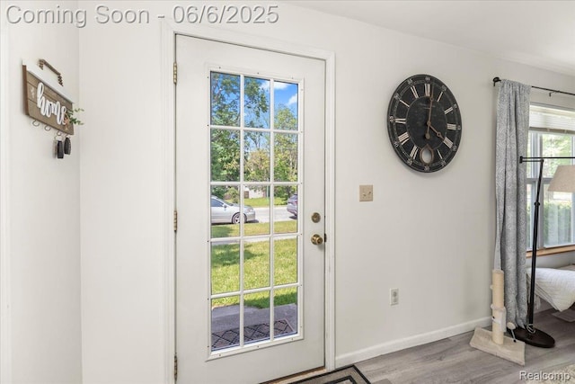 501 Front St, Holly, MI 48442 - doorway to outside featuring wood finished floors and baseboards