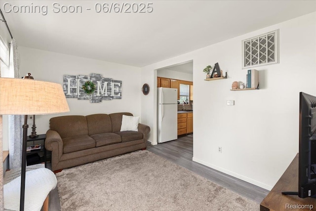 501 Front St, Holly, MI 48442 - living area with dark wood finished floors and baseboards