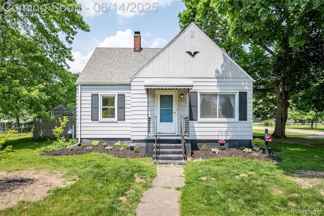 2375 Nichols Ave, Grand Blanc, MI 48507 - bungalow-style house with a shingled roof, a chimney, and board and batten siding