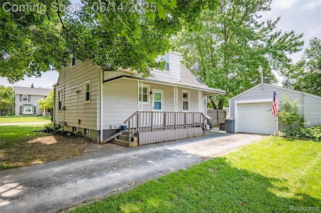 2375 Nichols Ave, Grand Blanc, MI 48507 - view of front facade featuring driveway, covered porch, an outbuilding, and a front lawn