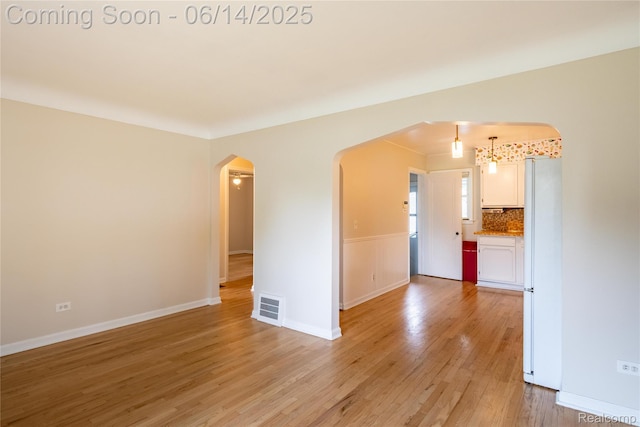 2375 Nichols Ave, Grand Blanc, MI 48507 - unfurnished room with arched walkways and light wood-type flooring