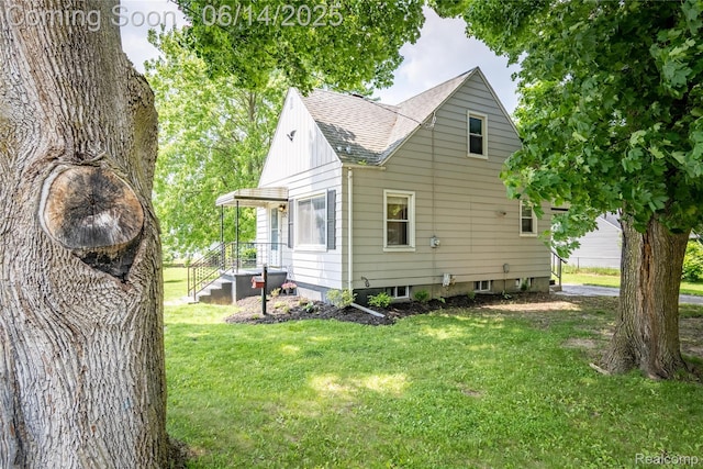 2375 Nichols Ave, Grand Blanc, MI 48507 - view of side of home with a shingled roof and a yard
