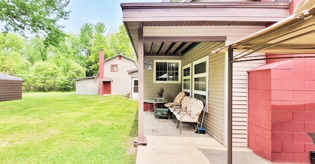 1308 Beaver Rd, Bitely, MI 49309 - view of green lawn featuring an outdoor structure and a patio