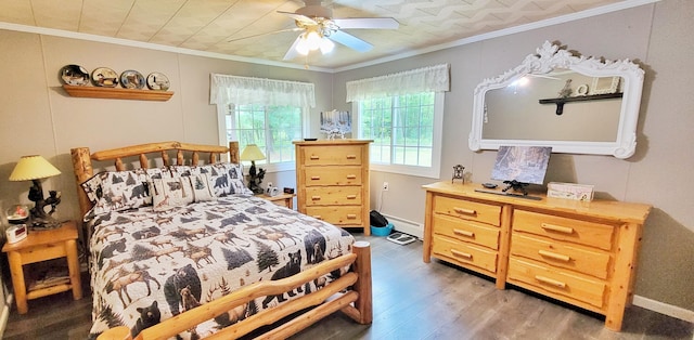1308 Beaver Rd, Bitely, MI 49309 - bedroom with light wood finished floors, crown molding, a baseboard radiator, a ceiling fan, and baseboards