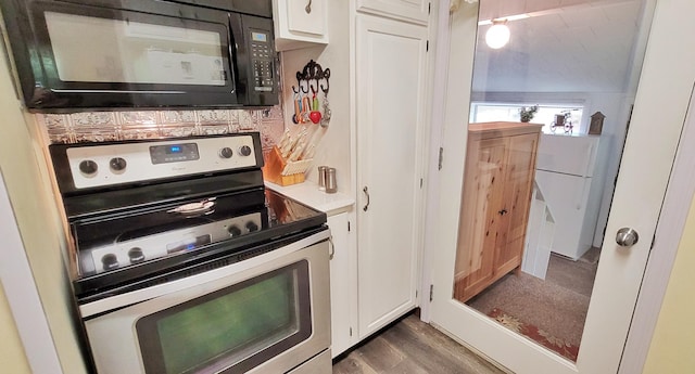1308 Beaver Rd, Bitely, MI 49309 - kitchen featuring electric range, black microwave, white cabinetry, wood finished floors, and light countertops
