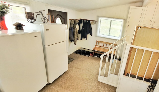 1308 Beaver Rd, Bitely, MI 49309 - kitchen featuring light colored carpet, freestanding refrigerator, plenty of natural light, vaulted ceiling, and baseboard heating
