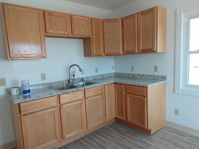 27 Rose St SW, Grand Rapids, MI 49507 - kitchen featuring a sink, light wood finished floors, light countertops, and light brown cabinets