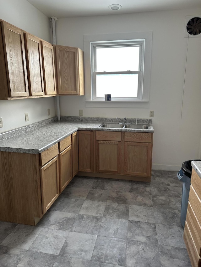 27 Rose St SW, Grand Rapids, MI 49507 - kitchen featuring a sink, baseboards, and stone finish floors
