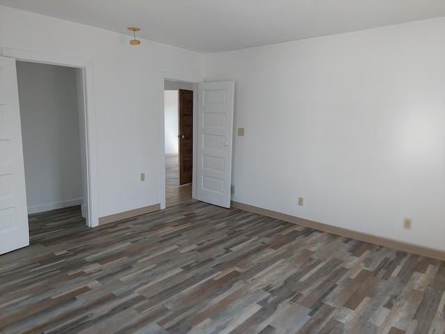 27 Rose St SW, Grand Rapids, MI 49507 - unfurnished bedroom with wood finished floors and baseboards