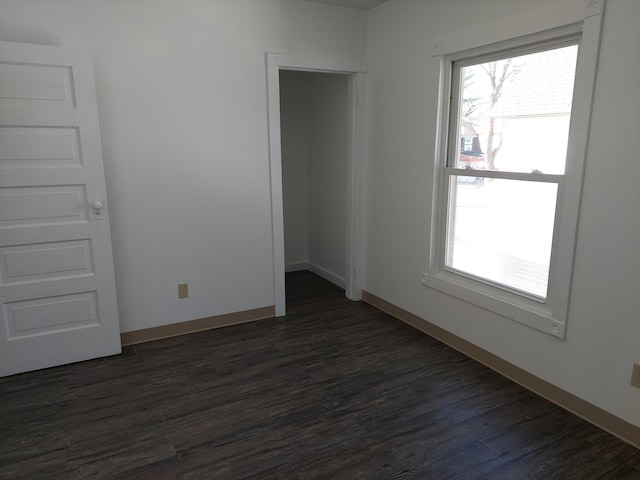 27 Rose St SW, Grand Rapids, MI 49507 - unfurnished room with healthy amount of natural light, dark wood-style floors, and baseboards
