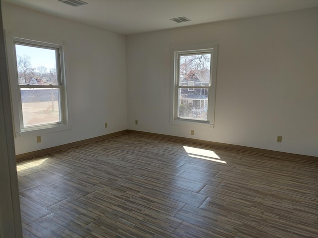 27 Rose St SW, Grand Rapids, MI 49507 - empty room featuring dark wood finished floors and baseboards