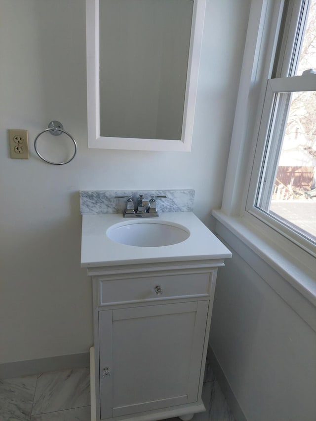 27 Rose St SW, Grand Rapids, MI 49507 - bathroom featuring marble finish floors, vanity, and baseboards