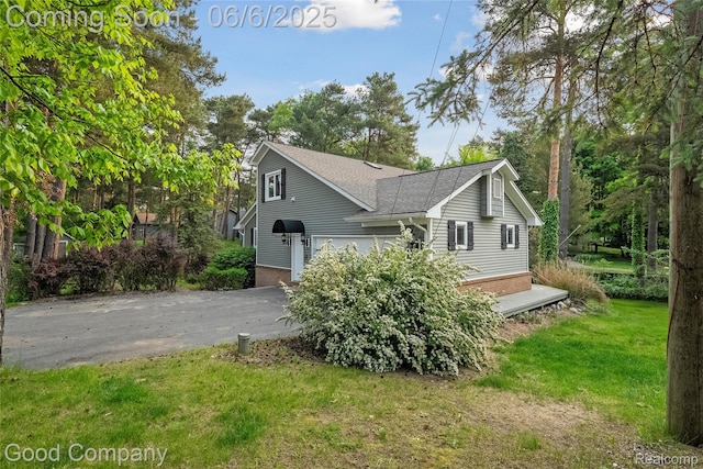 5490 Clarkston Rd, Clarkston, MI 48348 - view of home's exterior featuring asphalt driveway, a shingled roof, and a yard