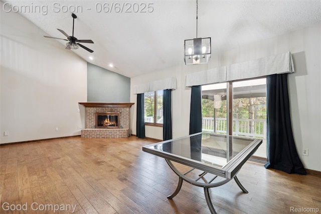 5490 Clarkston Rd, Clarkston, MI 48348 - dining space with hardwood / wood-style floors, a ceiling fan, high vaulted ceiling, a brick fireplace, and recessed lighting