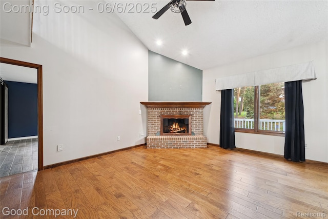 5490 Clarkston Rd, Clarkston, MI 48348 - unfurnished living room with ceiling fan, hardwood / wood-style floors, a fireplace, high vaulted ceiling, and baseboards